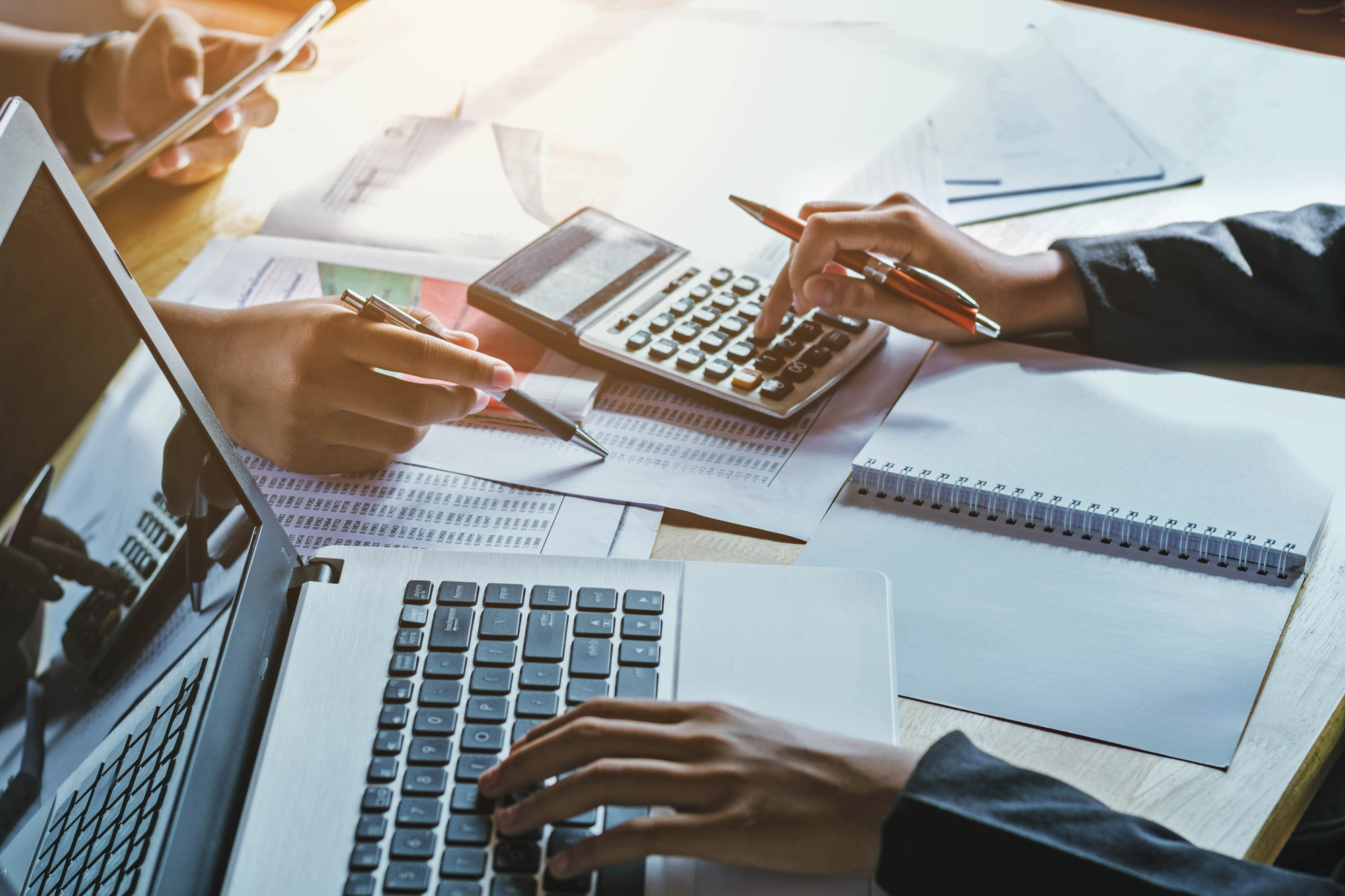 Professionals reviewing financial documents and accounting records in Hope